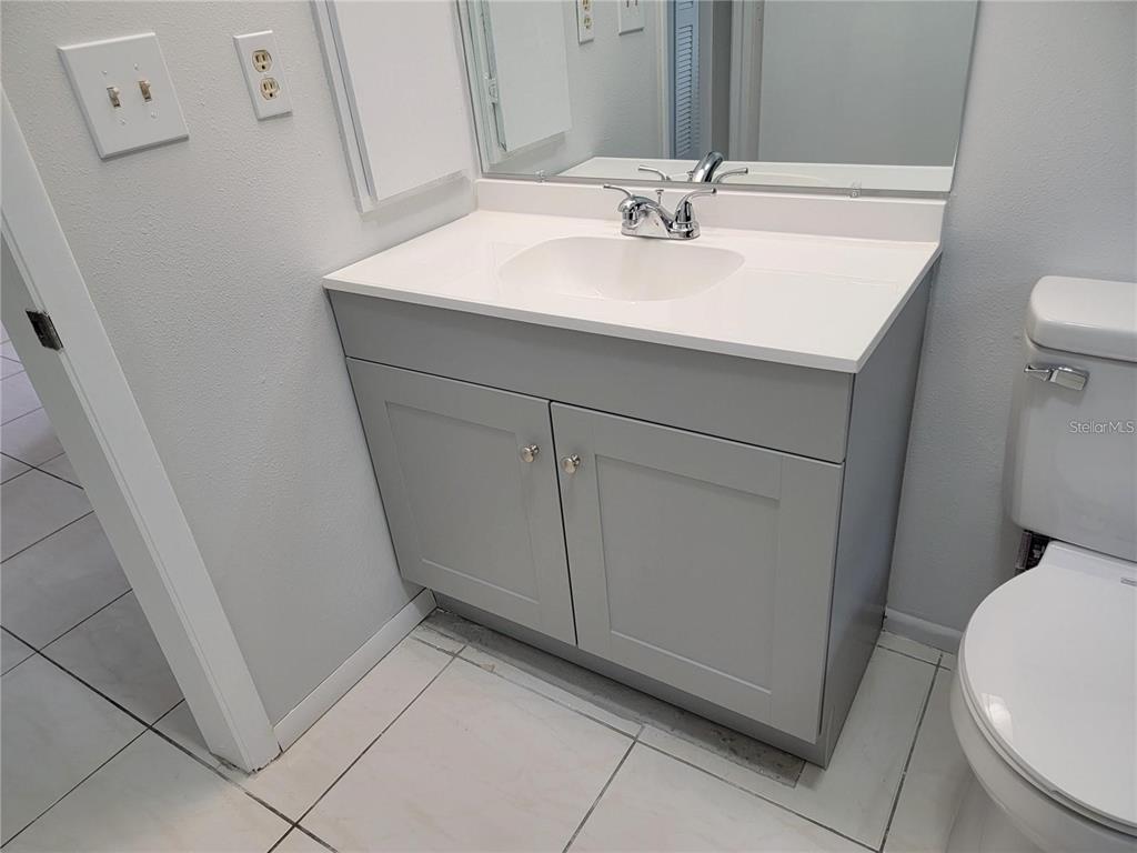 26221 Constantine Road Punta Gorda, FL 33983 - Photo 17 of 27 a bathroom with a sink toilet and mirror