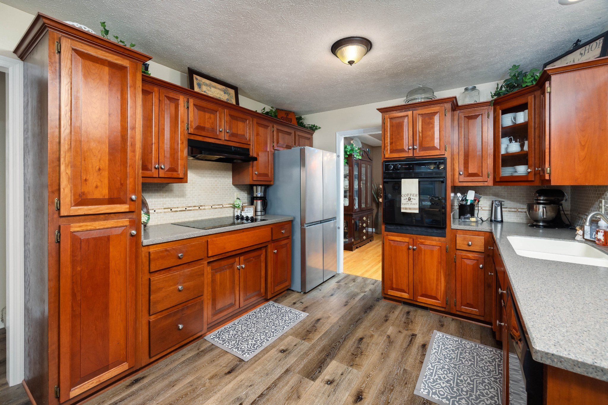 232 Trice Road Lebanon, TN 37087 - Photo 17 of 43 a kitchen with stainless steel appliances granite countertop a refrigerator a stove and a sink with wooden cabinets