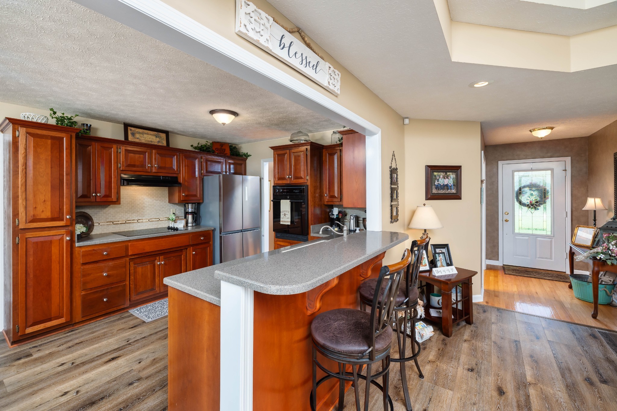 232 Trice Road Lebanon, TN 37087 - Photo 21 of 43 a kitchen with stainless steel appliances granite countertop wooden cabinets a dining table and chairs