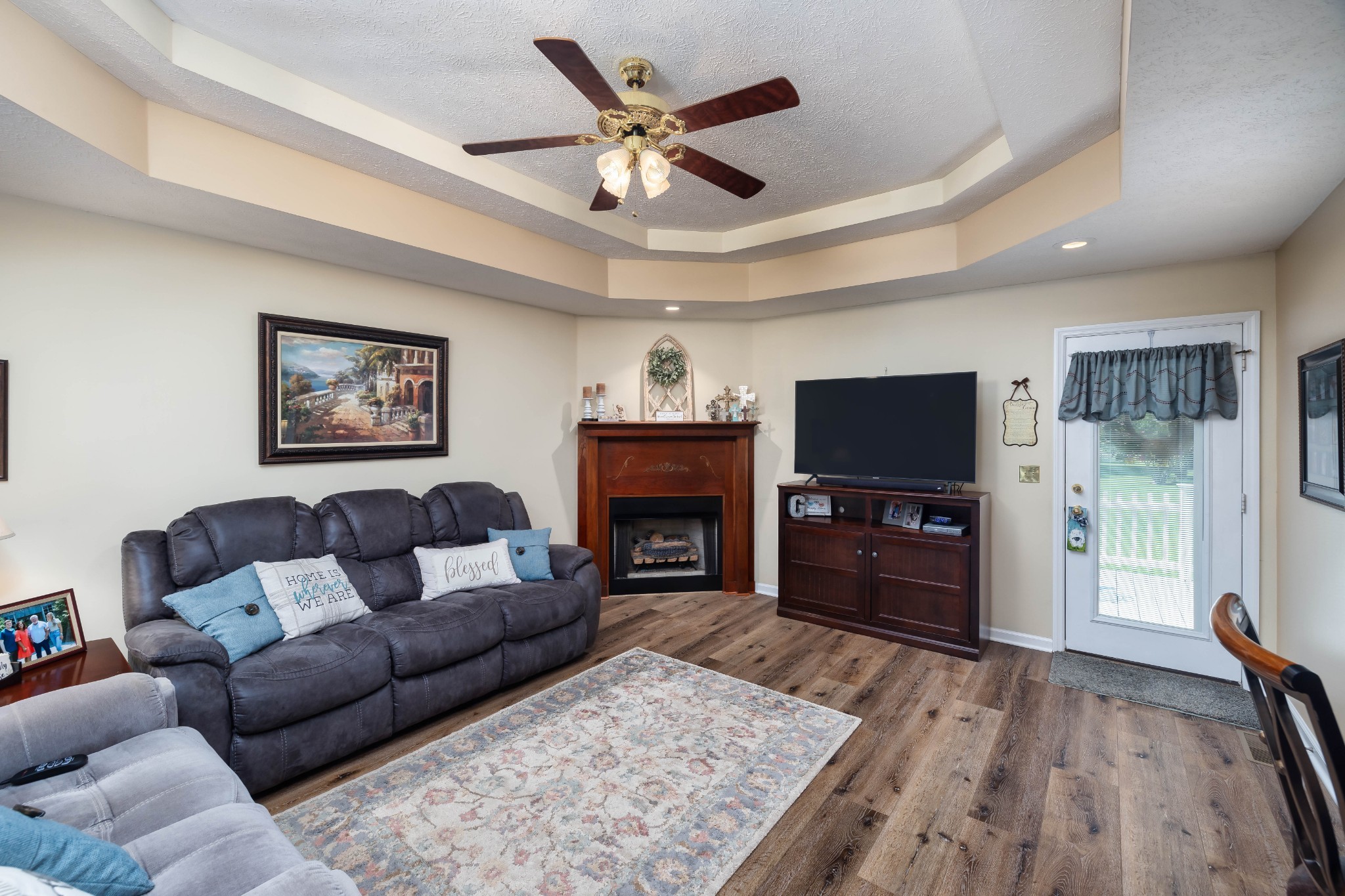 232 Trice Road Lebanon, TN 37087 - Photo 25 of 43 a living room with furniture a fireplace and a flat screen tv