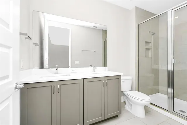 a bathroom with a toilet a sink and a mirror