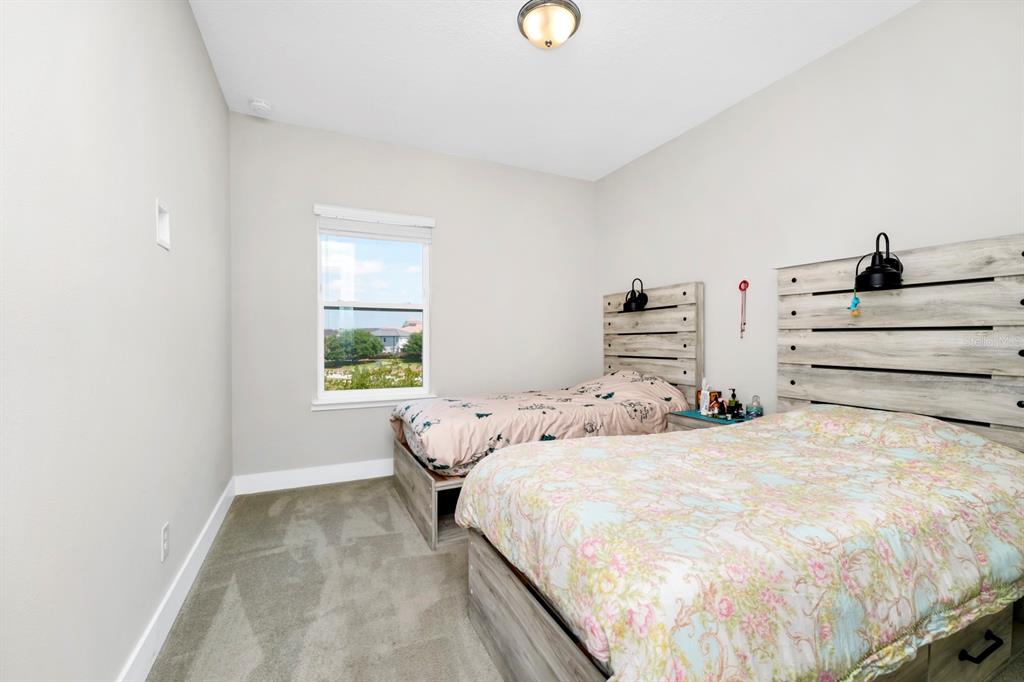 743 Driving Range Court Reunion, FL 34747 - Photo 14 of 38 a bedroom with a bed and a window