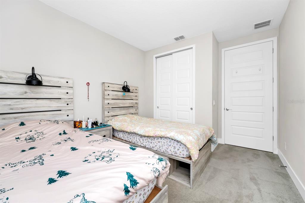 743 Driving Range Court Reunion, FL 34747 - Photo 15 of 38 a bedroom with a bed and cabinets