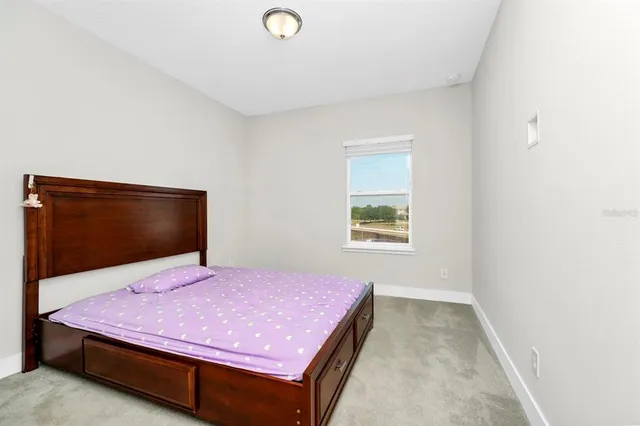 a bedroom with a bed and window