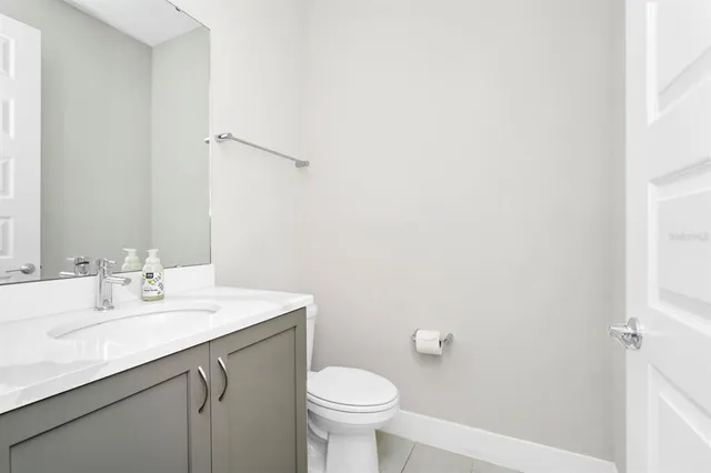 a bathroom with a sink a toilet and mirror