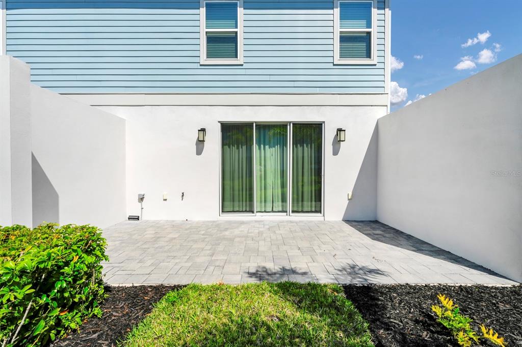 743 Driving Range Court Reunion, FL 34747 - Photo 23 of 38 a front view of a house with a yard and potted plants