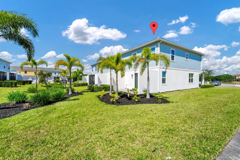 743 Driving Range Court Reunion, FL 34747 - Photo 24 of 38 a view of a white house with a big yard and potted plants