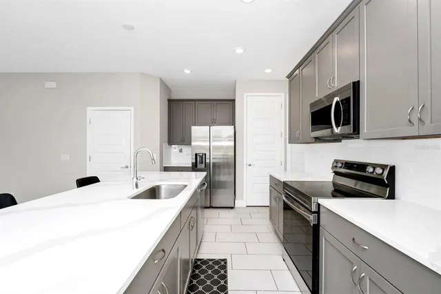 a kitchen with a sink stove and microwave