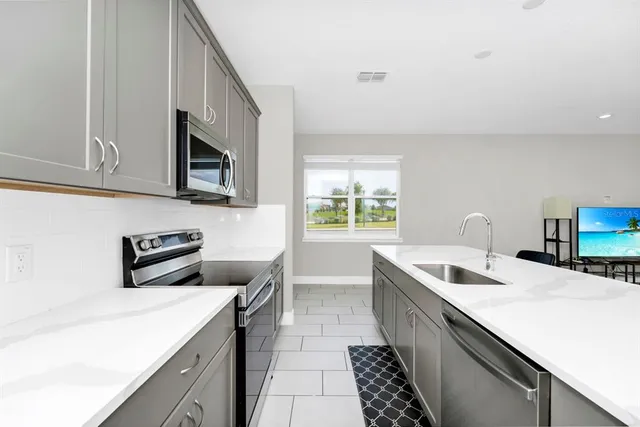 a kitchen that has a sink and a stove