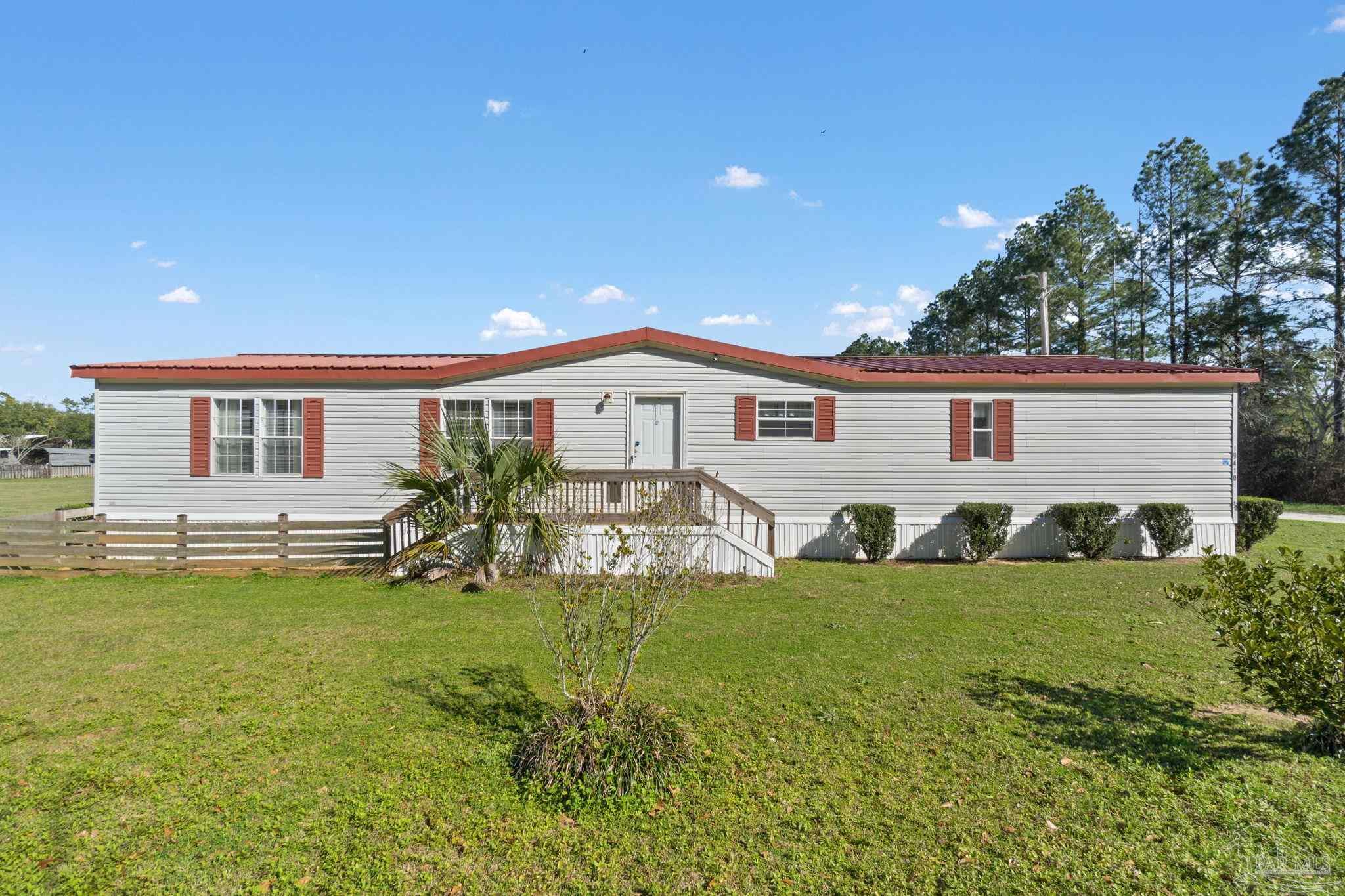 19410 Hunting Club Road Seminole, AL 36574 - Photo 1 of 49 a view of a white house with a big yard and potted plants