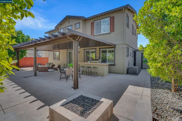 a view of a house with backyard and sitting area