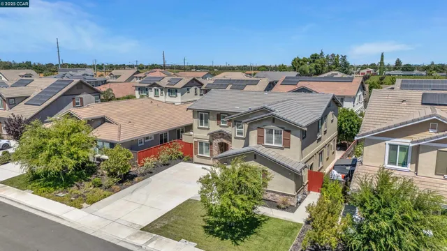an aerial view of a house with a yard basket ball court and outdoor seating