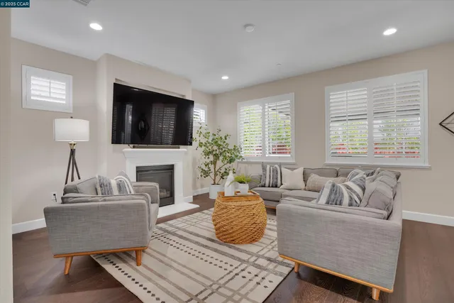 a living room with furniture a fireplace and a flat screen tv