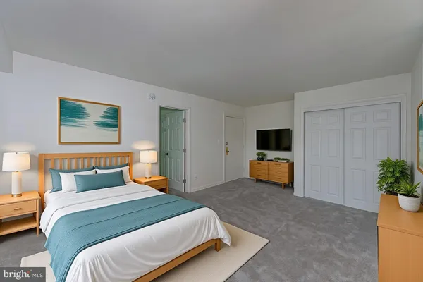 a bedroom with a bed and a couch