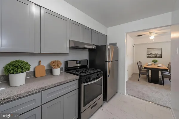 a kitchen with a refrigerator and cabinets