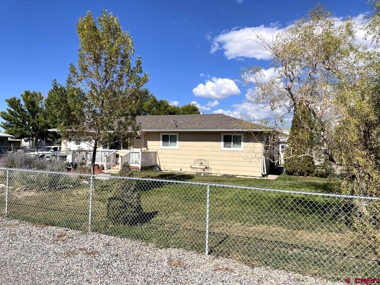 1201 Frontier Road Delta, CO 81416 - Photo 14 of 21 a front view of a house with a yard