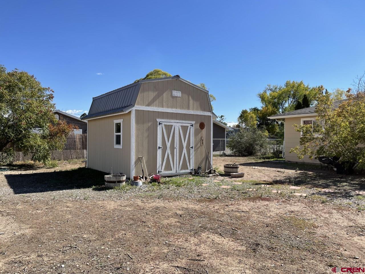 1201 Frontier Road Delta, CO 81416 - Photo 18 of 21 a view of a house with backyard and trees