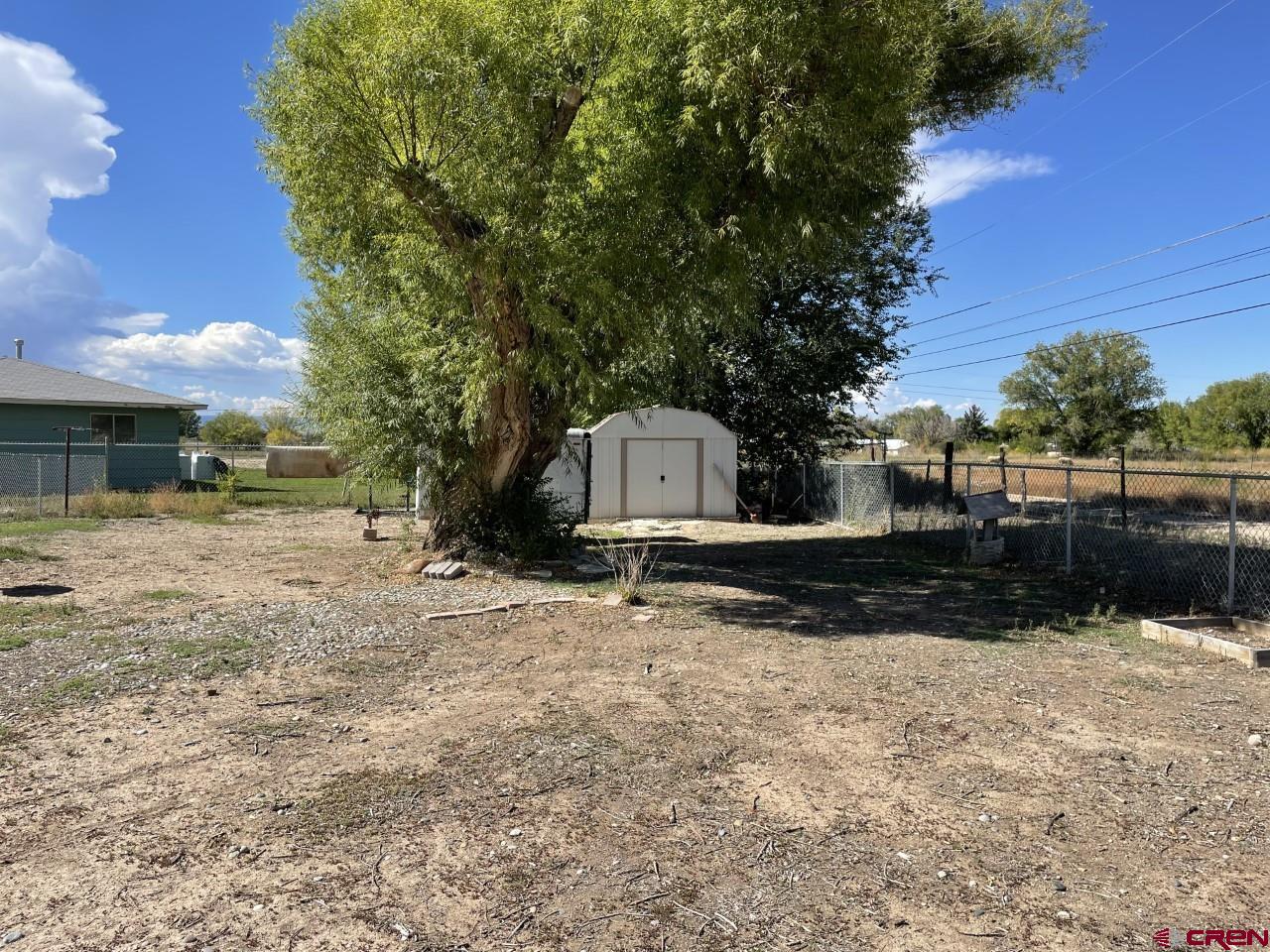1201 Frontier Road Delta, CO 81416 - Photo 20 of 21 a backyard of a house with lots of green space
