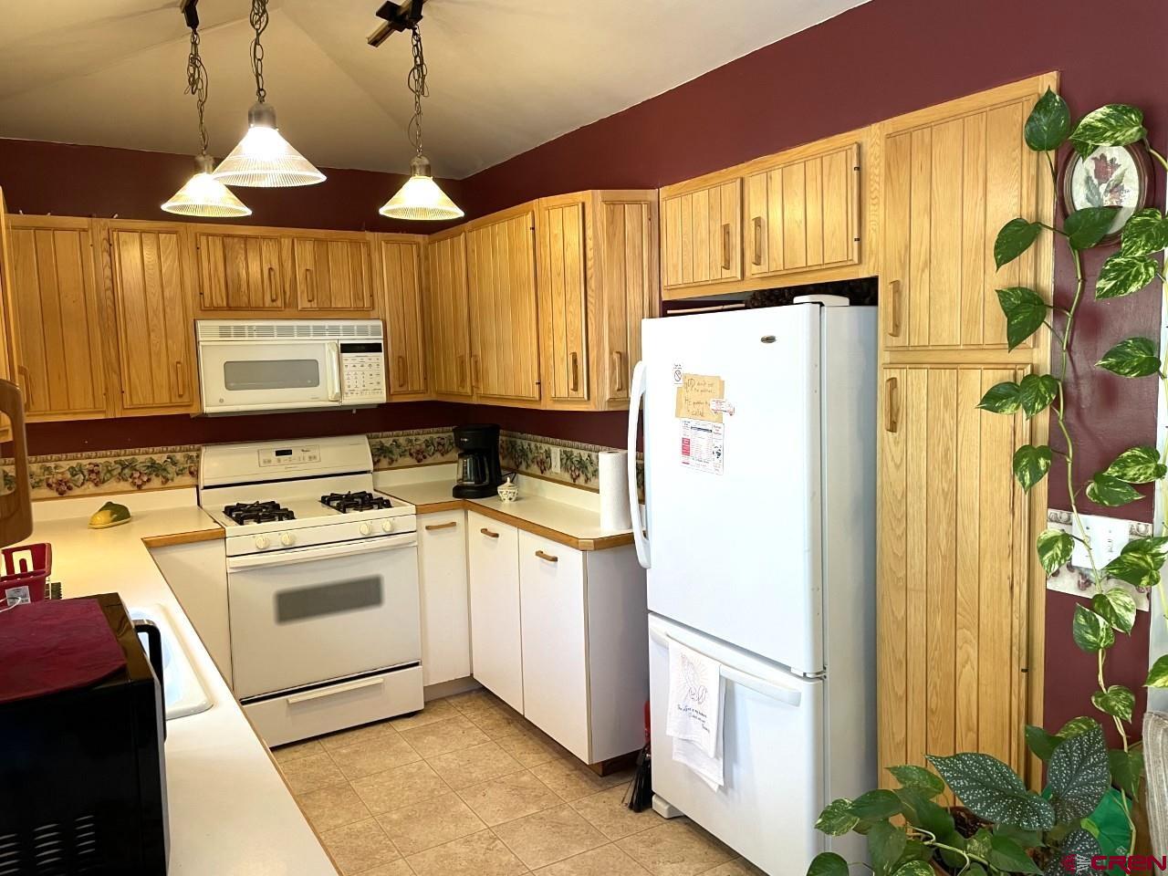 1201 Frontier Road Delta, CO 81416 - Photo 4 of 21 a white refrigerator freezer sitting inside of a kitchen