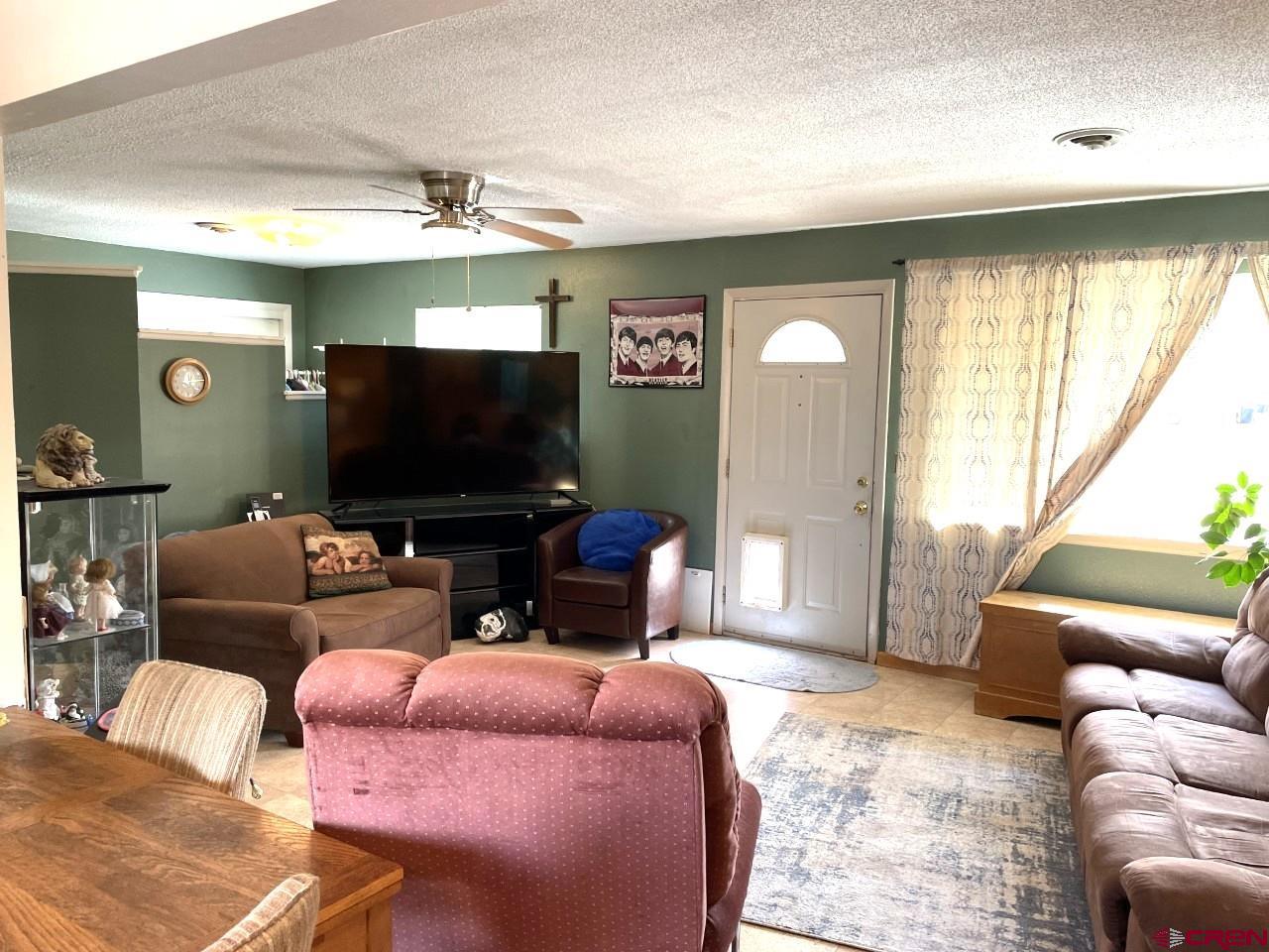1201 Frontier Road Delta, CO 81416 - Photo 8 of 21 a living room with furniture and a flat screen tv