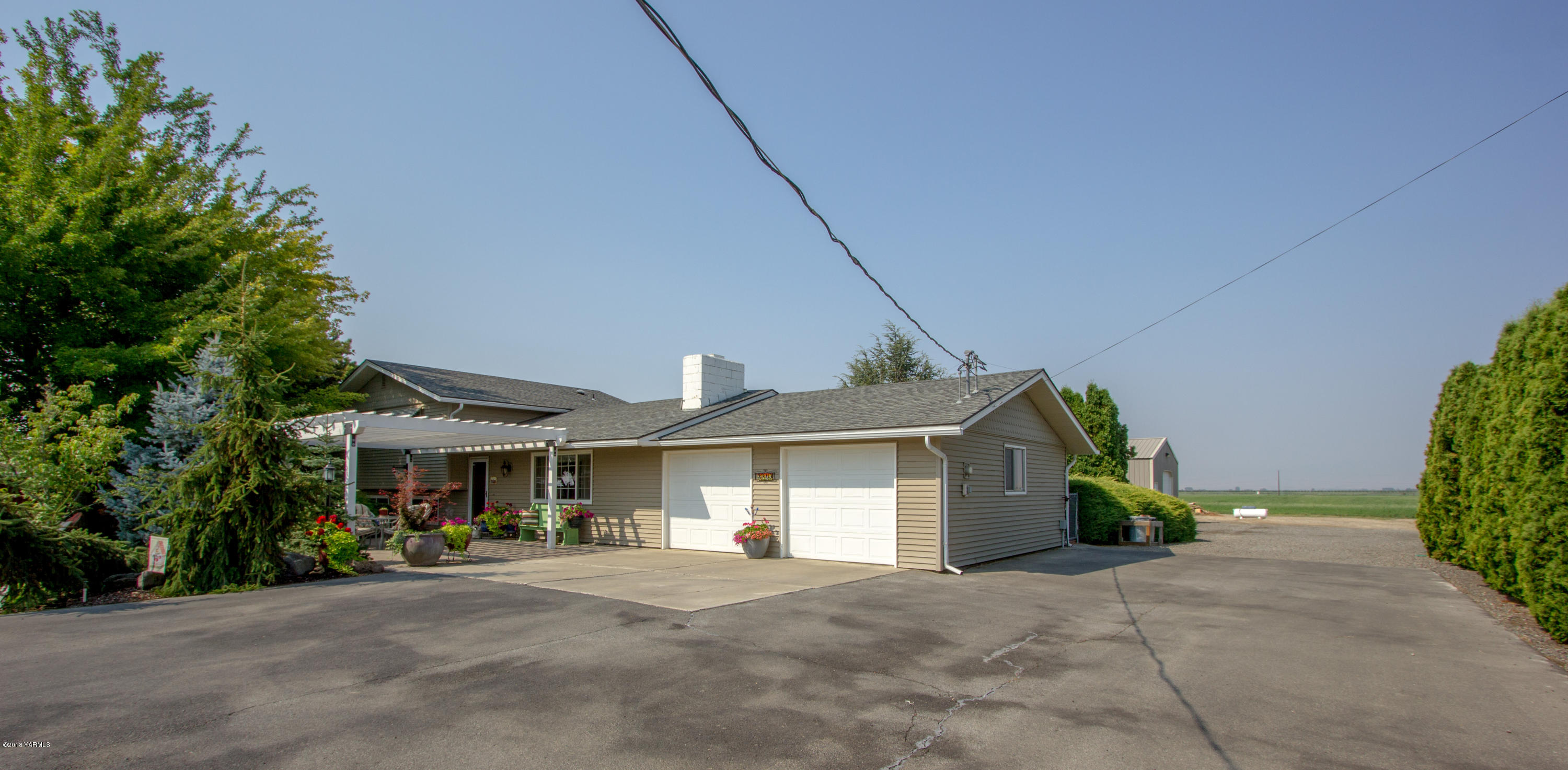 3210 Harrah Road Harrah, WA 98933 - Photo 2 of 33 a front view of a house with a garden and patio