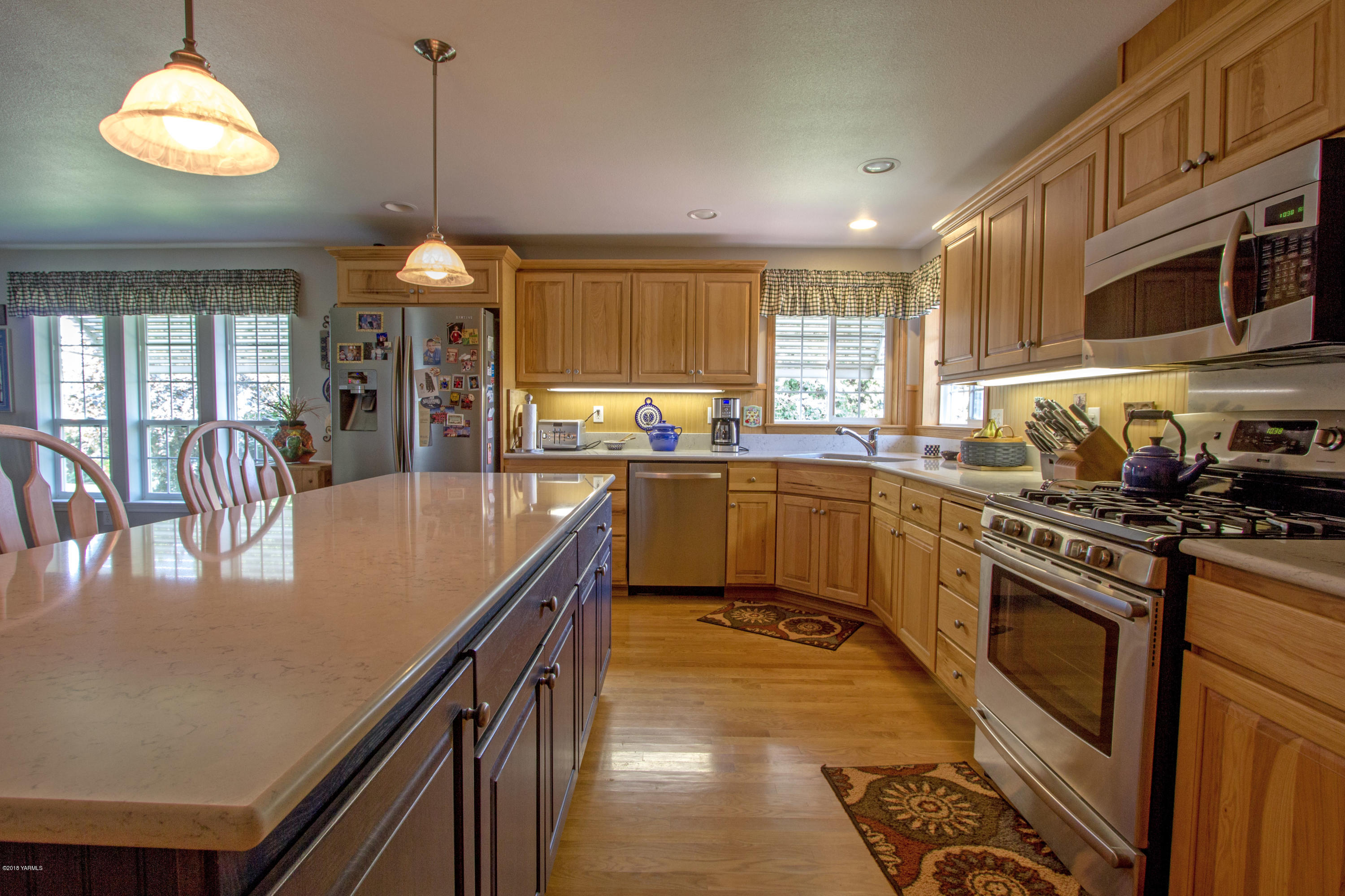 3210 Harrah Road Harrah, WA 98933 - Photo 17 of 33 a kitchen with stainless steel appliances granite countertop a sink a stove top oven a counter space cabinets and a window