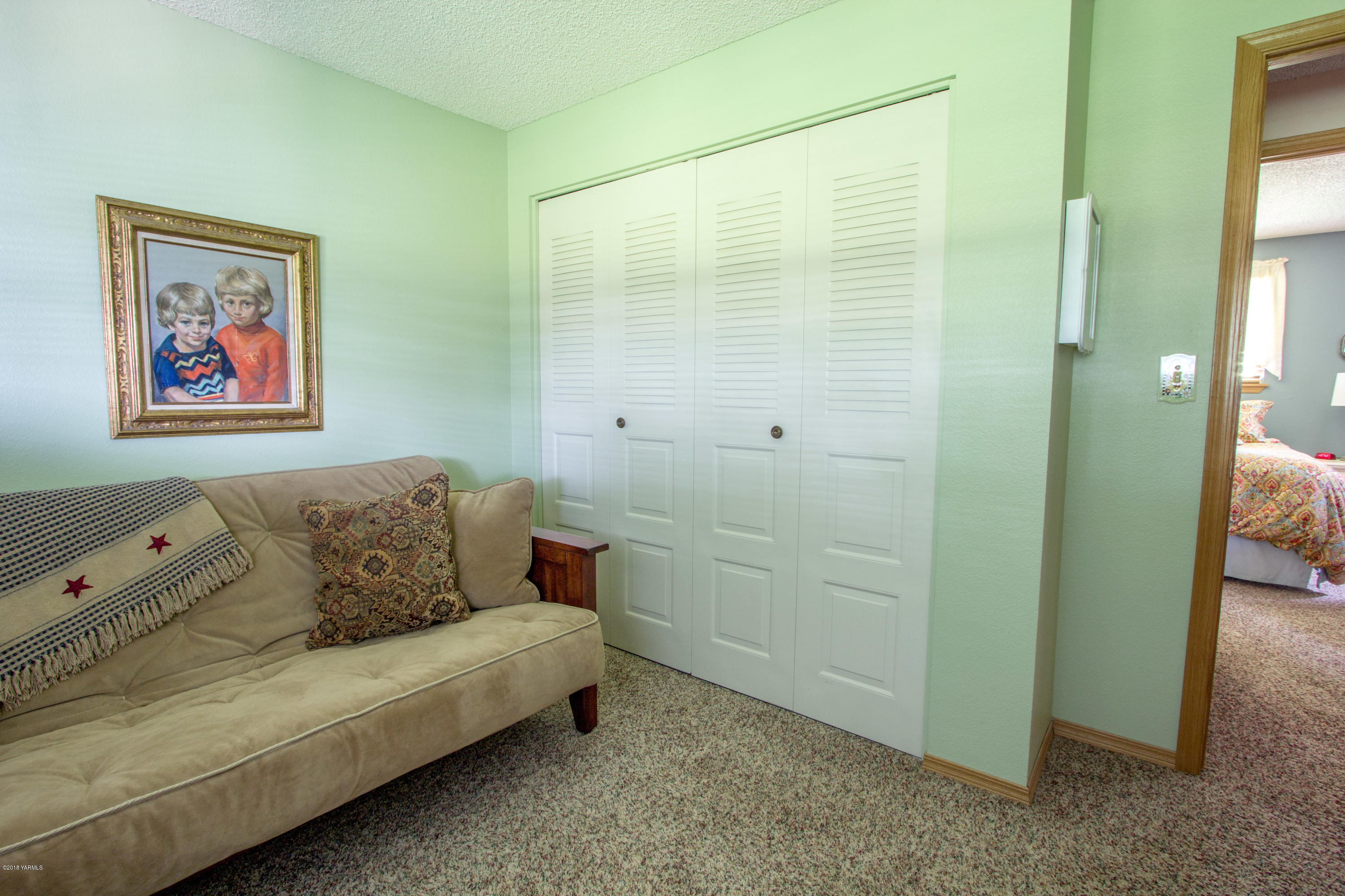 3210 Harrah Road Harrah, WA 98933 - Photo 25 of 33 a blue couch sitting in a bathroom next to a bathroom