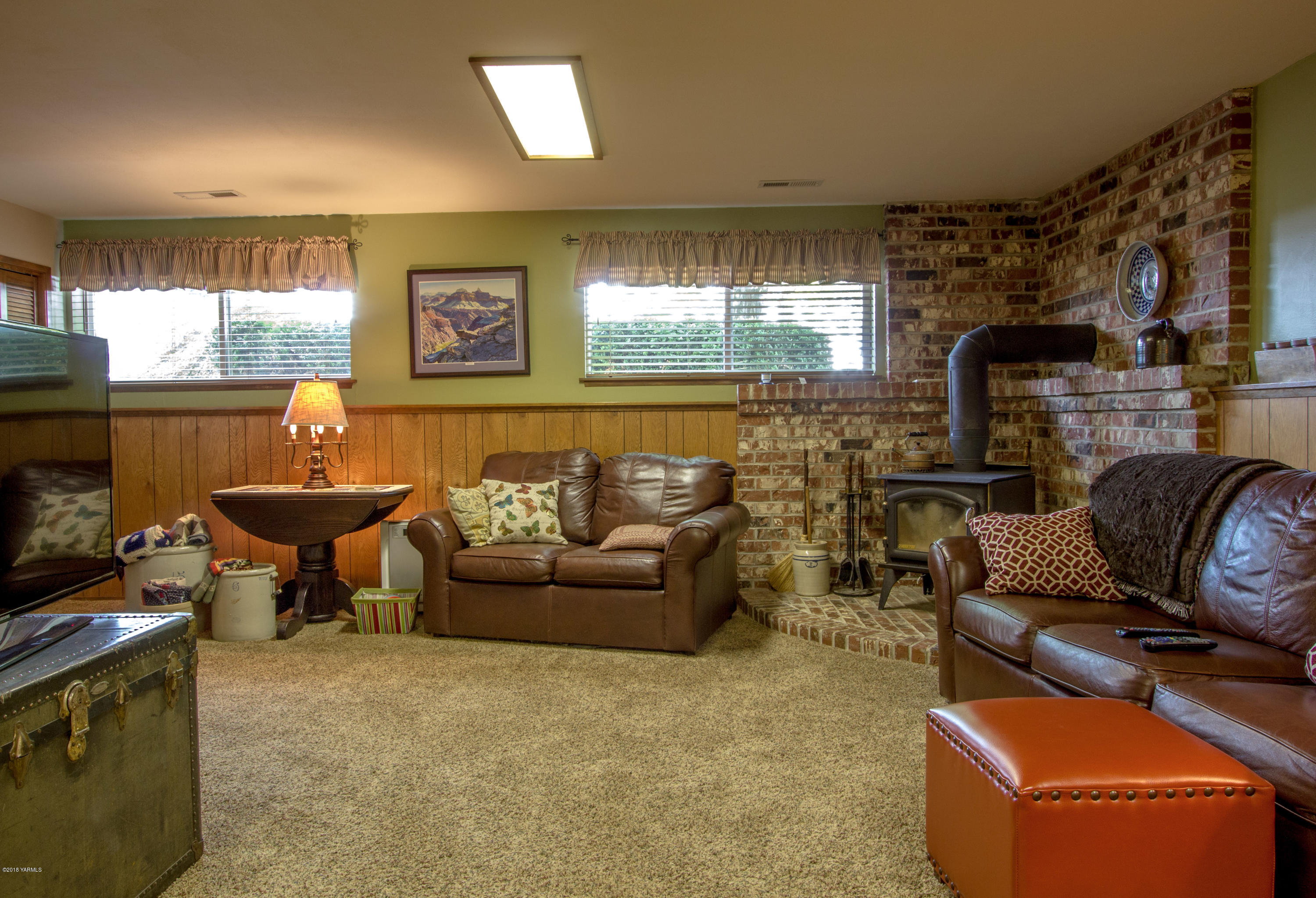 3210 Harrah Road Harrah, WA 98933 - Photo 30 of 33 a living room with furniture a large window and a fireplace