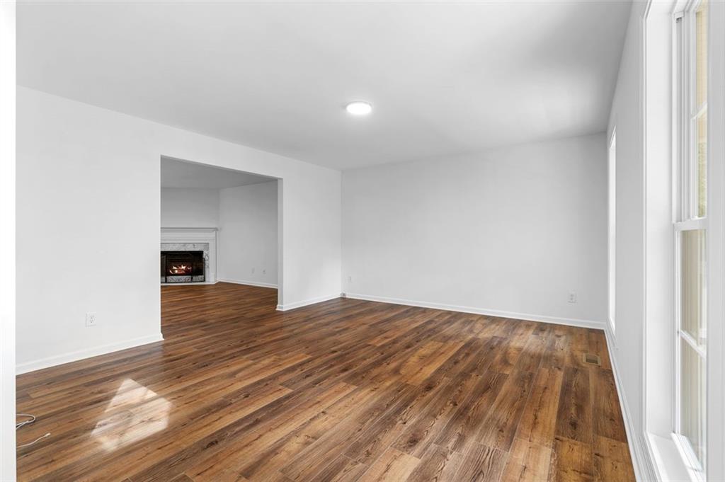 80 Castle Court Ellijay, GA 30540 - Photo 11 of 39 a view of empty room with wooden floor and fireplace