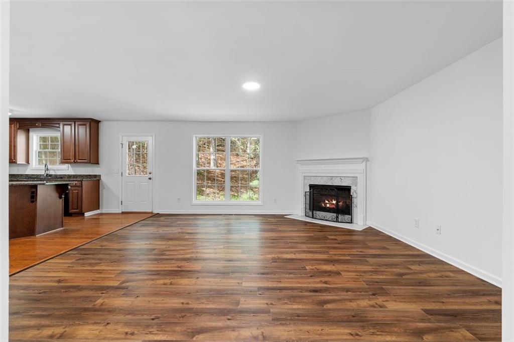 80 Castle Court Ellijay, GA 30540 - Photo 12 of 39 a view of an empty room with a fireplace and a window