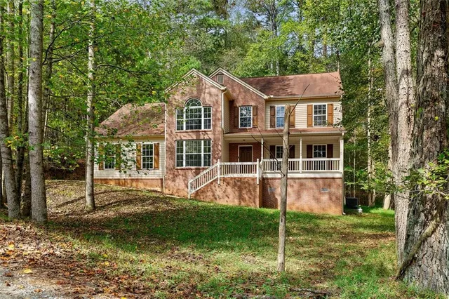 a view of a house with a yard and sitting area