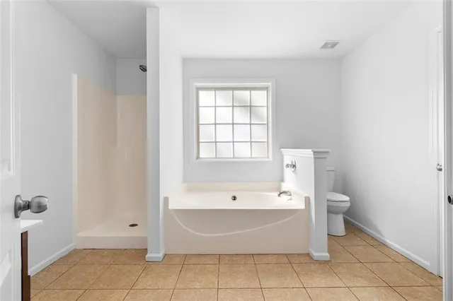 a bathroom with a granite countertop sink mirror and cabinets