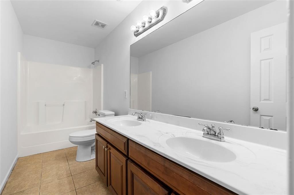 80 Castle Court Ellijay, GA 30540 - Photo 31 of 39 a bathroom with a double vanity sink and a mirror