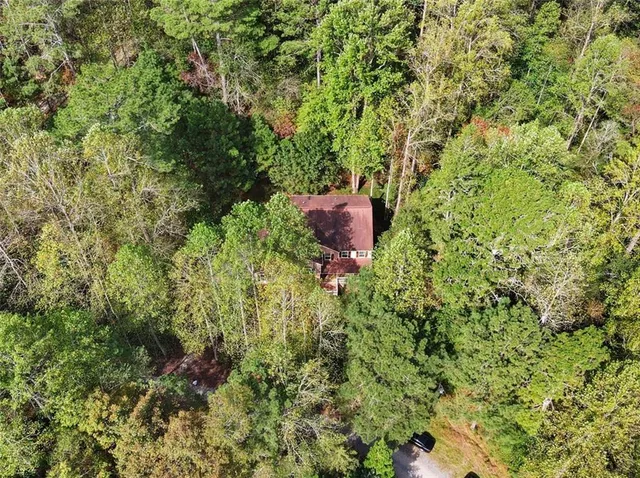 an aerial view of a house with a yard