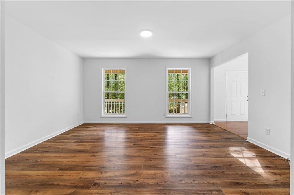 80 Castle Court Ellijay, GA 30540 - Photo 8 of 37 an empty room with wooden floor and windows