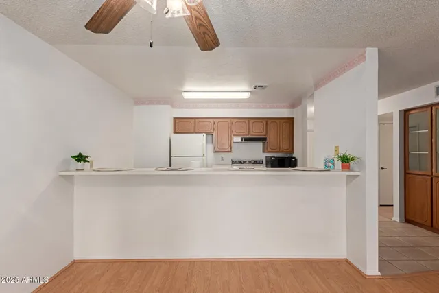 a view of kitchen with furniture and refrigerator