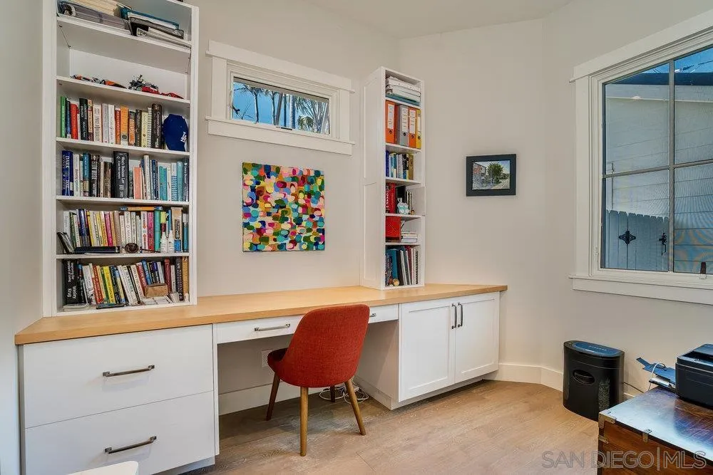 5769 Waverly Avenue La Jolla, CA 92037 - Photo 12 of 30 a workspace with furniture and a book shelf