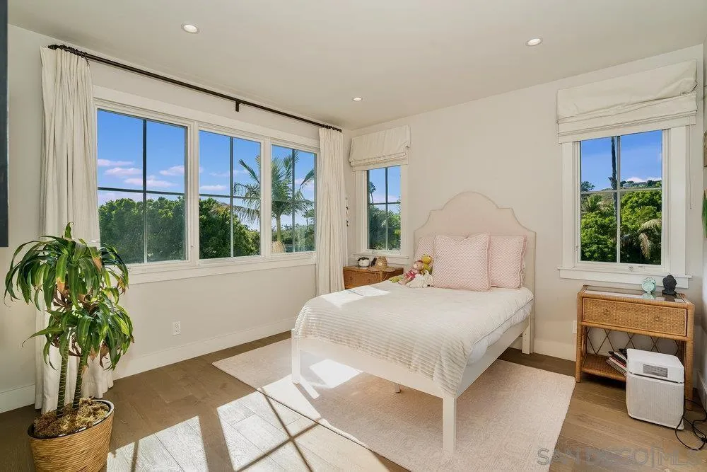 5769 Waverly Avenue La Jolla, CA 92037 - Photo 17 of 30 a bedroom with a large bed and a large window