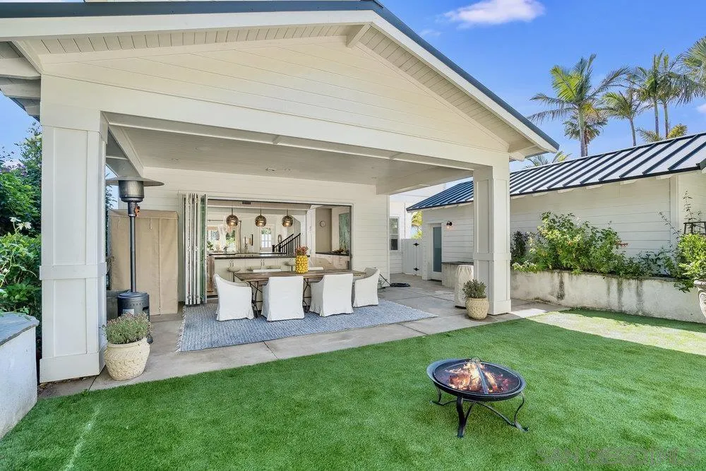5769 Waverly Avenue La Jolla, CA 92037 - Photo 23 of 30 a view of a backyard with table and chairs and potted plants