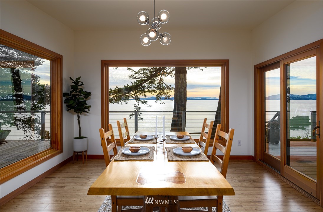 340 Cove Road Bellingham, WA 98229 - Photo 14 of 40 a view of a dining room with furniture large windows and wooden floor