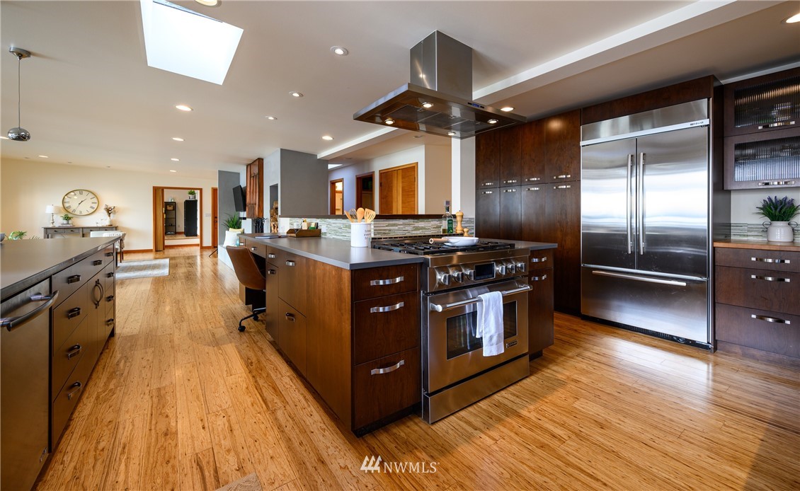 340 Cove Road Bellingham, WA 98229 - Photo 15 of 40 a kitchen with stainless steel appliances granite countertop a stove a sink dishwasher and a refrigerator with wooden floor