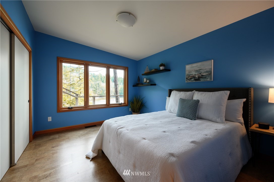 340 Cove Road Bellingham, WA 98229 - Photo 23 of 40 a bed sitting in a bedroom next to a window
