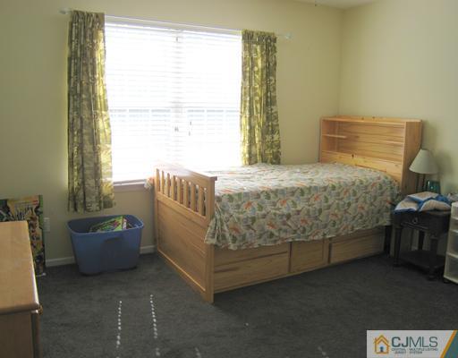 5 Old Ridge Road Monmouth Junction, NJ 08852 - Photo 18 of 24 a bed sitting in a bedroom next to a window