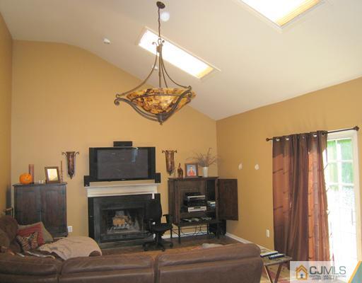 5 Old Ridge Road Monmouth Junction, NJ 08852 - Photo 7 of 24 a living room with furniture a chandelier and a fireplace