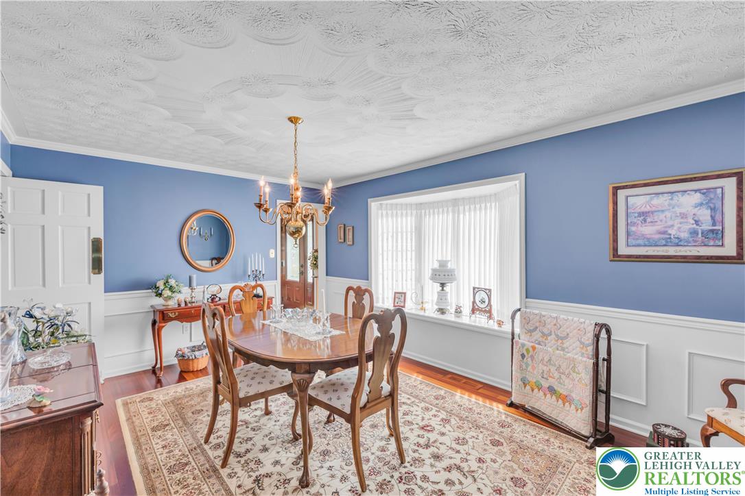 4059 Old Sentry Road Allentown, PA 18104 - Photo 7 of 39 A classic dining area boasts hardwood floors and a statement chandelier, perfect for formal gatherings.