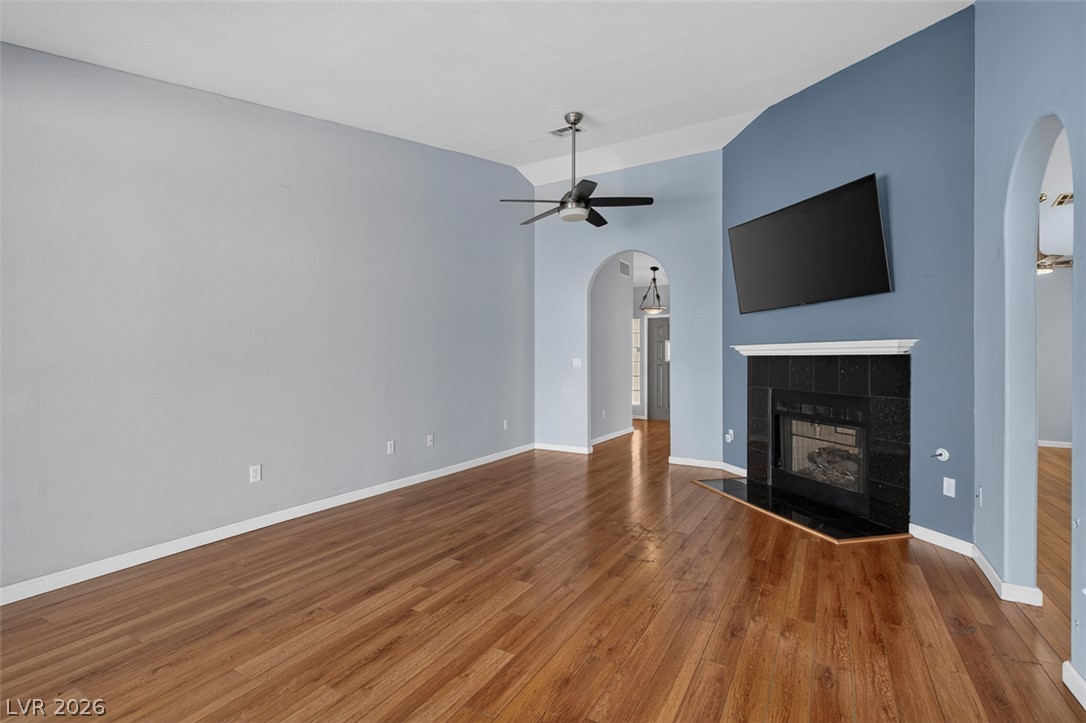 2609 Shakespeare Road Las Vegas, NV 89108 - Photo 14 of 41 Refined wood flooring flows through this bright family room, centered around a sleek fireplace.