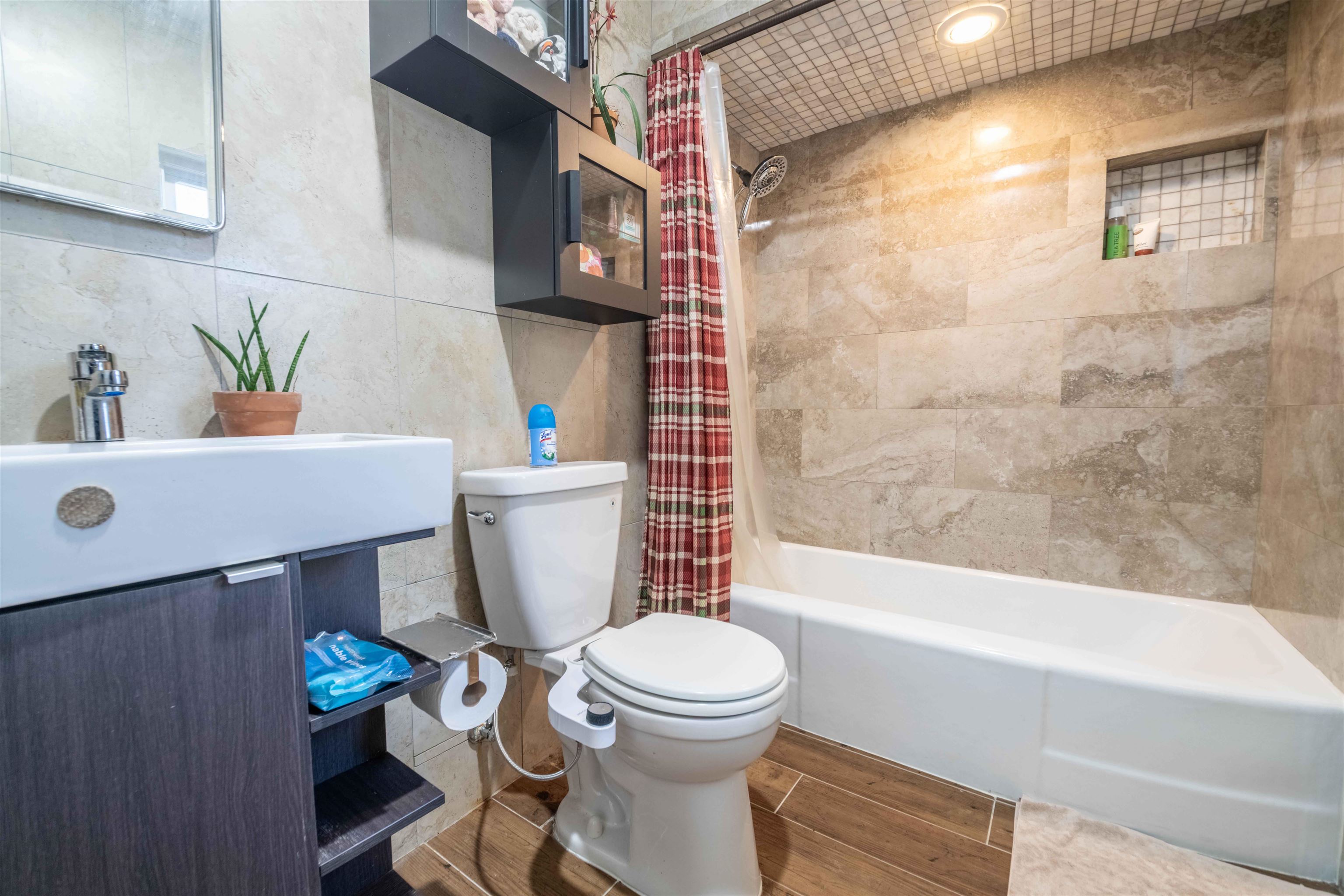 5099 Walnut Grove Road Memphis, TN 38117 - Photo 19 of 24 Full bathroom featuring tile walls, shower / tub combo, vanity, wood tiled floors, and recessed lighting
