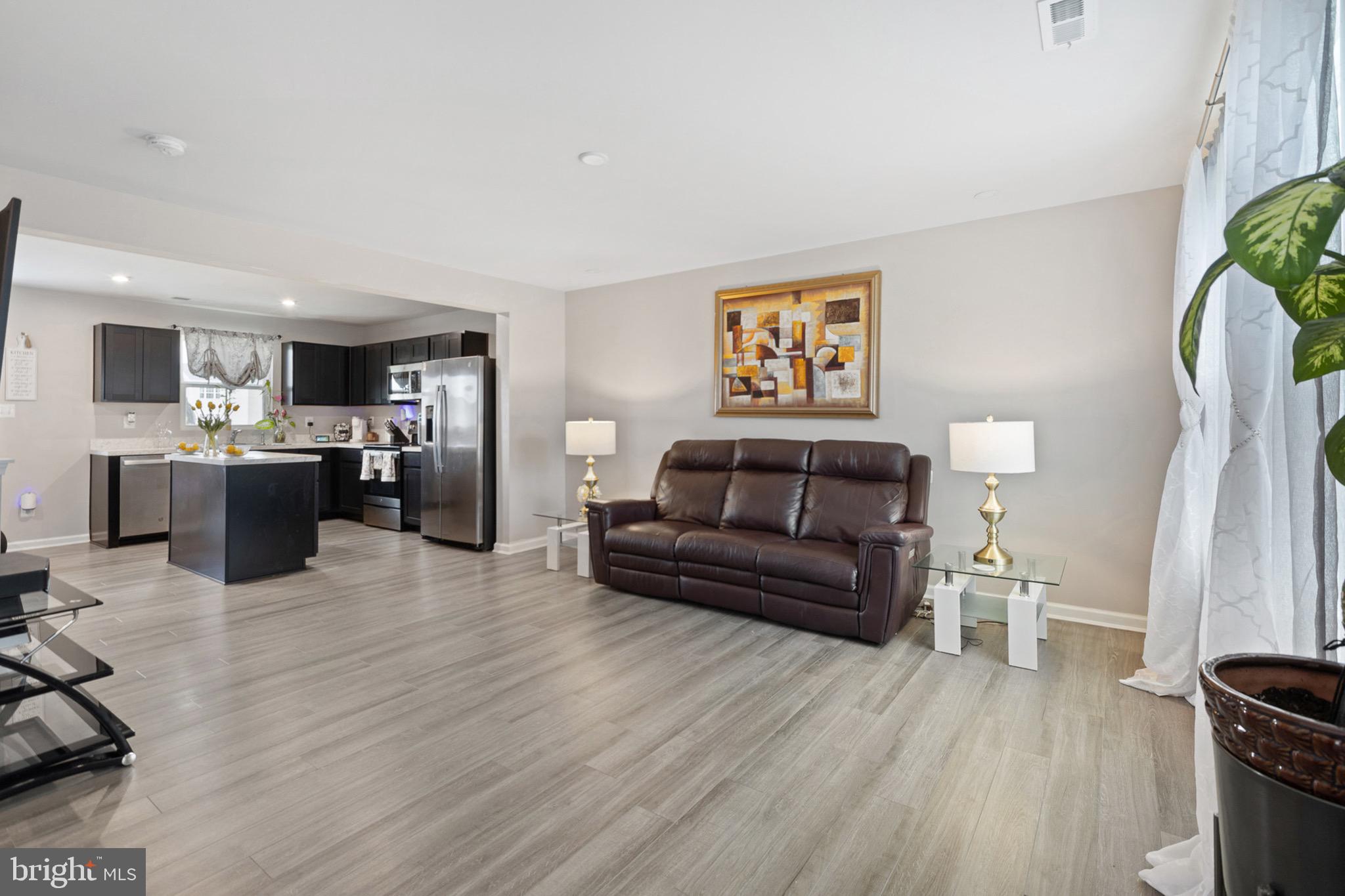 1049 Wickersham Way Middletown, DE 19709 - Photo 12 of 33 a living room with furniture and a wooden floor