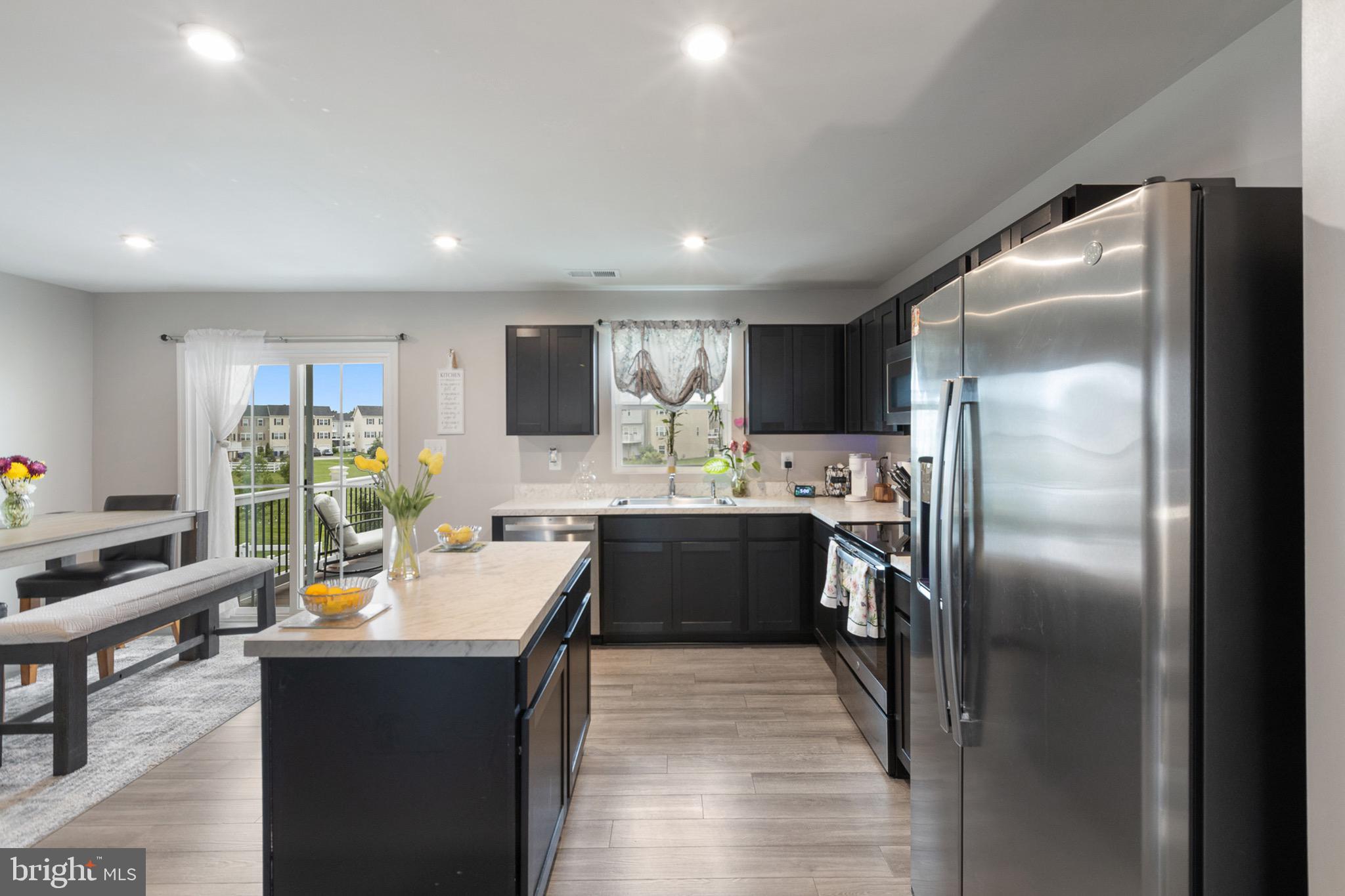 1049 Wickersham Way Middletown, DE 19709 - Photo 14 of 33 a large kitchen with a large counter top appliances and cabinets