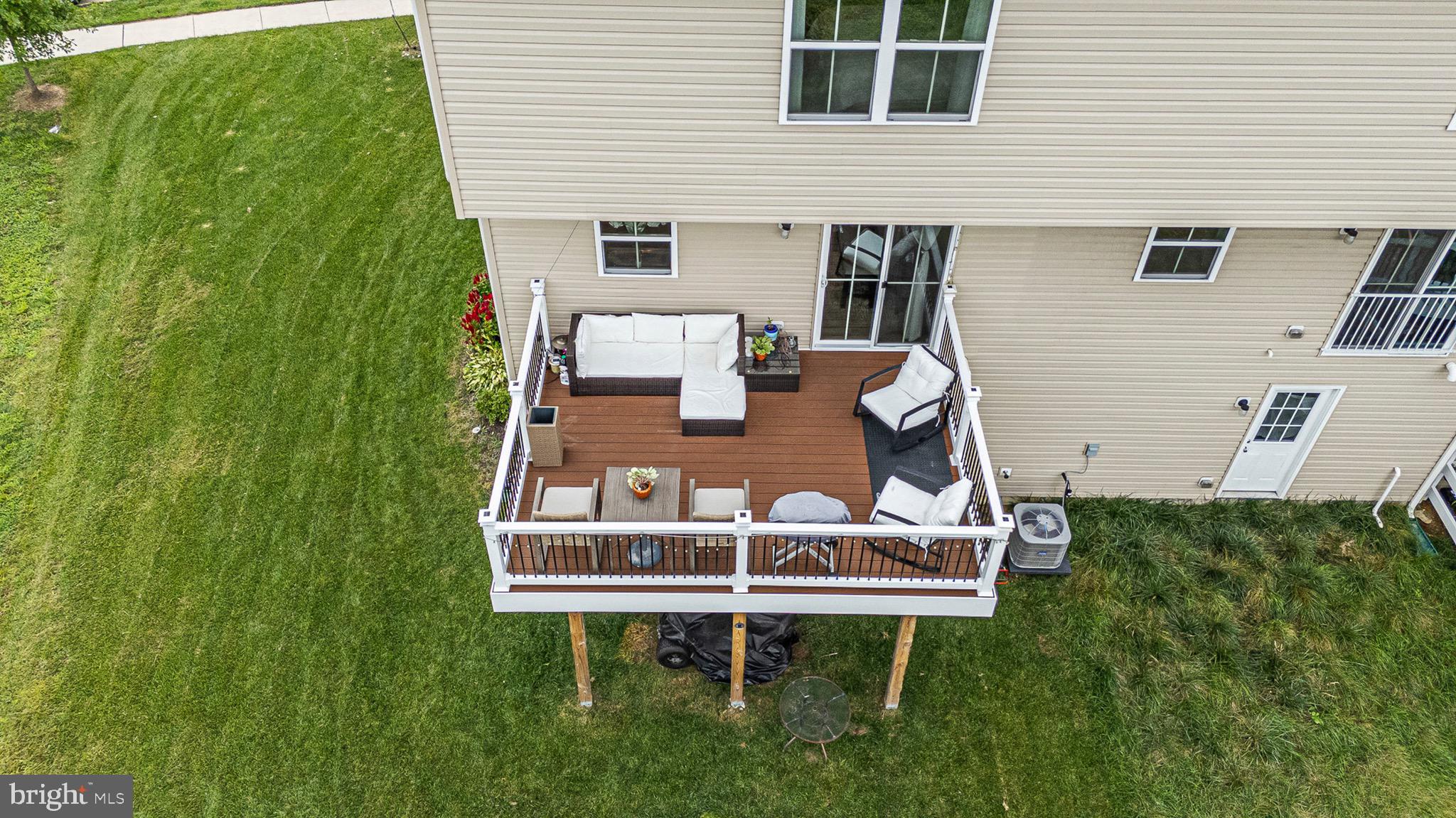1049 Wickersham Way Middletown, DE 19709 - Photo 30 of 33 a wooden bench sitting in front of a house